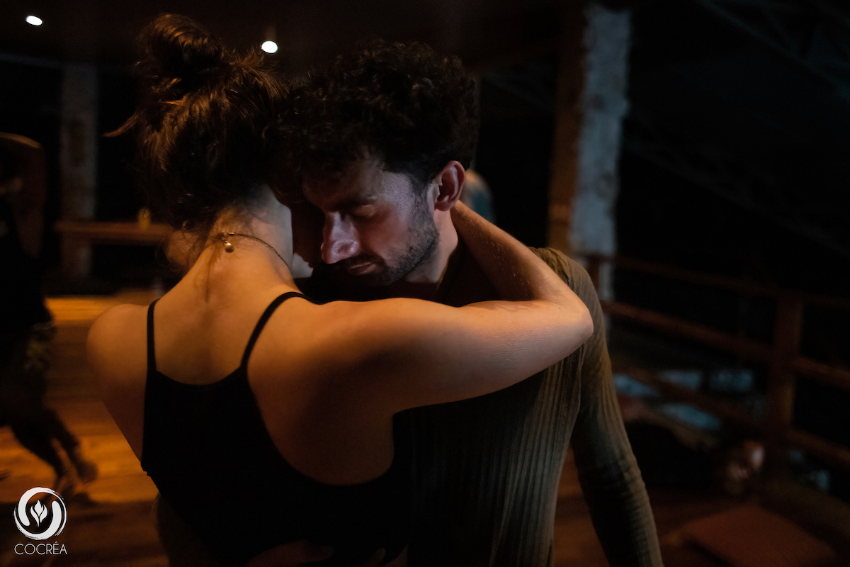 Toby Israel and a male partner display closeness and connection during a dance performance.