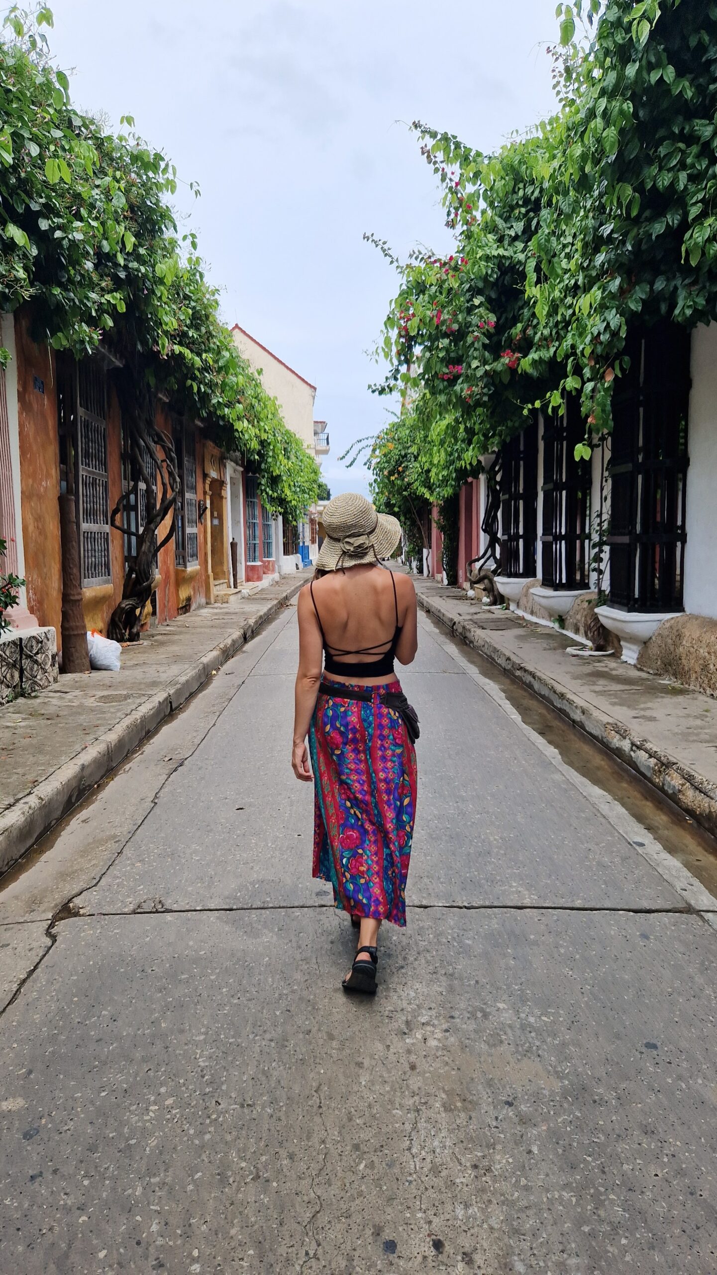 Toby Israel walking between colorful houses — travel lifestyle